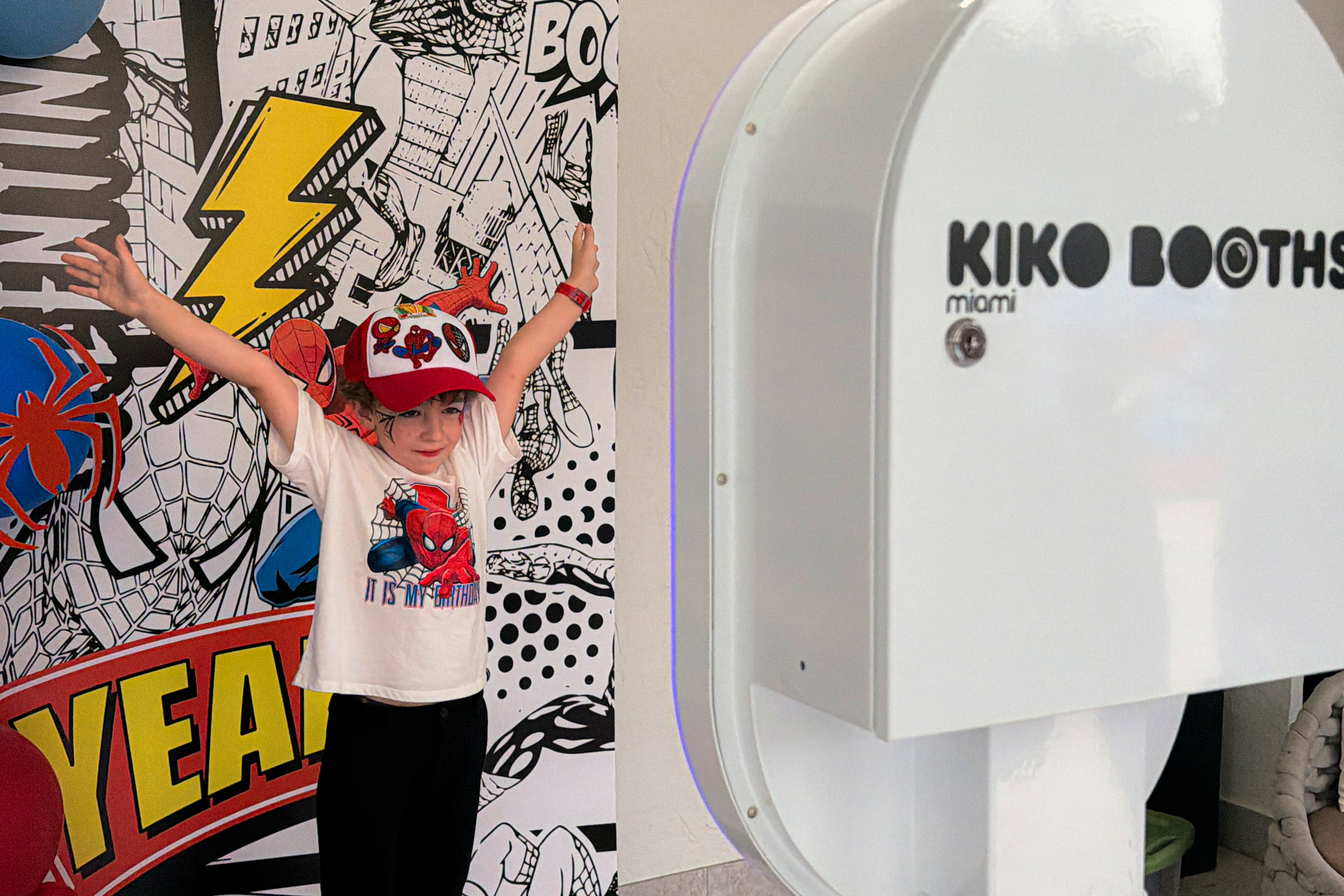 Boy celebrating his superhero birthday party next to the ARO photobooth in Miami