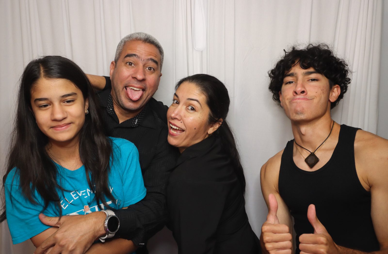 Family making funny faces at a Kiko Booths photobooth in South Florida