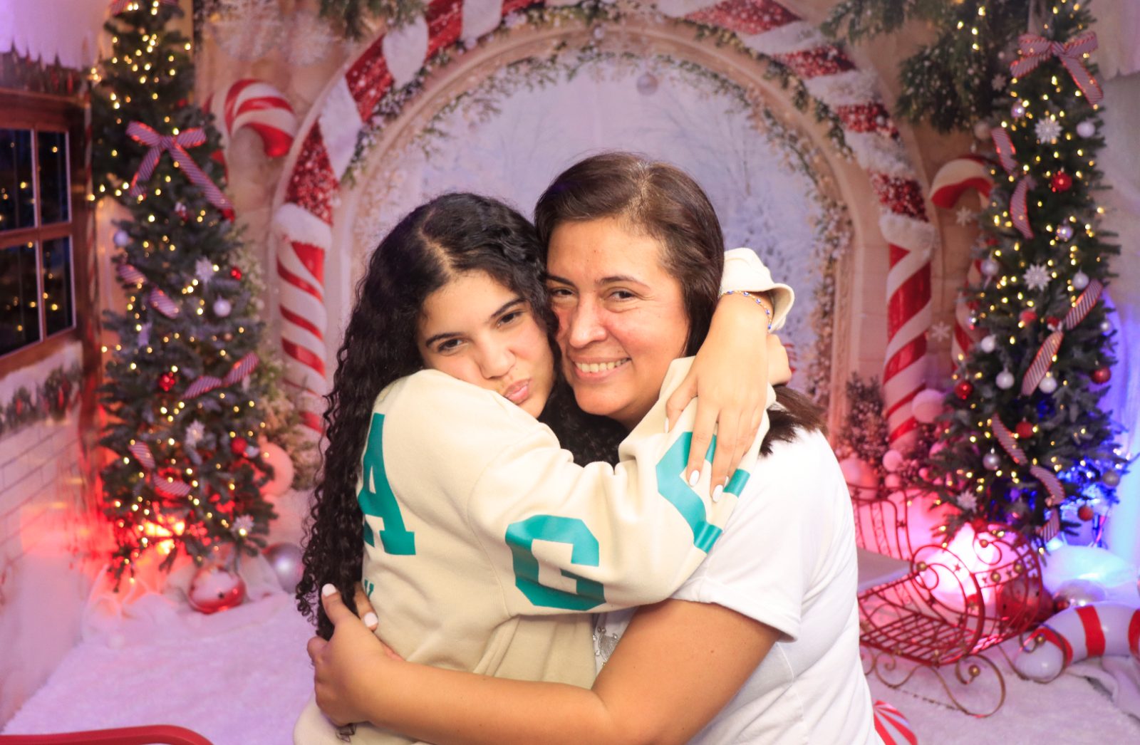 Mother and daughter hugging at a Kiko Booths holiday photobooth set