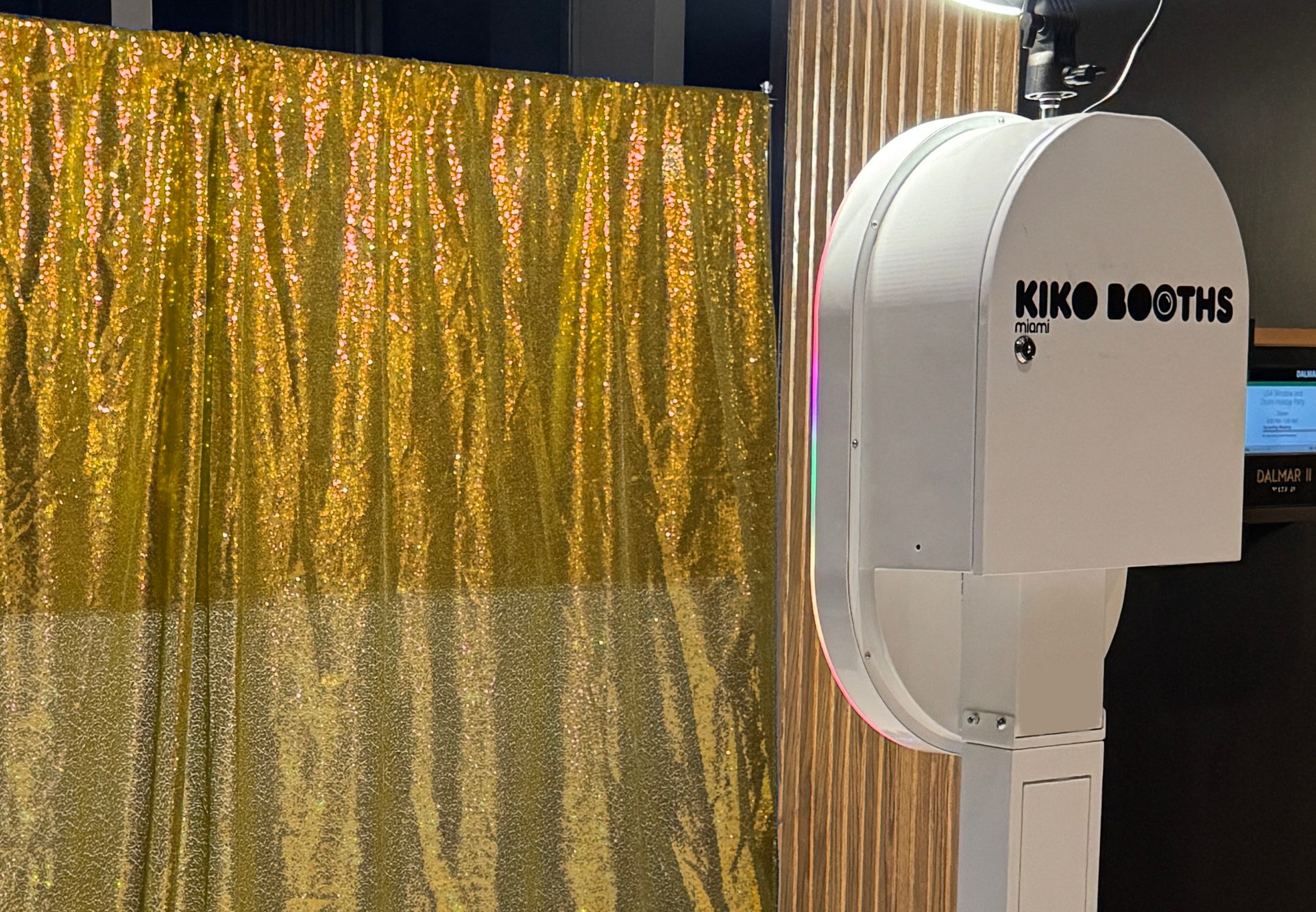 Kiko Booths ARO photobooth next to a gold sequin backdrop at a Miami venue
